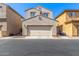 Two-story home with a two-car garage door and desert landscaping in the front yard at 7769 W Bonitos Dr, Phoenix, AZ 85035