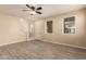 Inviting living room with neutral walls, ceiling fan, and staircase access at 7769 W Bonitos Dr, Phoenix, AZ 85035