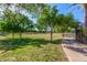 Green park area featuring lush lawns, mature trees, and a walking path at 7769 W Bonitos Dr, Phoenix, AZ 85035