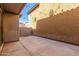 A cozy patio space with concrete flooring and textured stucco walls featuring festive string lights at 7769 W Bonitos Dr, Phoenix, AZ 85035