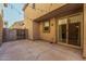 A private patio area with concrete pavers, a gate, and string lights above at 7769 W Bonitos Dr, Phoenix, AZ 85035