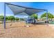 Playground featuring slides, swings, climbing structures, and a covered seating area for relaxation at 7769 W Bonitos Dr, Phoenix, AZ 85035
