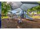 Community playground with slides and climbing structures under a shaded canopy at 7769 W Bonitos Dr, Phoenix, AZ 85035
