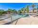 Community pool featuring a splash pad, shaded seating areas, and views of the surrounding homes at 7769 W Bonitos Dr, Phoenix, AZ 85035