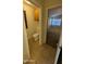 Cozy bathroom with neutral tiling, and a view into a carpeted bedroom with natural light at 8014 W Beaubien Dr, Peoria, AZ 85382