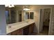 Bathroom with double sinks, a glass enclosed shower and walk in closet access at 8014 W Beaubien Dr, Peoria, AZ 85382