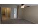 Bedroom featuring carpet and bathroom access through open doorway at 8014 W Beaubien Dr, Peoria, AZ 85382