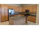 Modern kitchen with an island, stainless steel appliances, and tile flooring at 8014 W Beaubien Dr, Peoria, AZ 85382