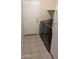 Functional laundry room with a washer and dryer, next to the backdoor and storage shelves at 8014 W Beaubien Dr, Peoria, AZ 85382