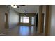 Bright living room featuring tile floors, a ceiling fan and large windows that let in plenty of natural light at 8014 W Beaubien Dr, Peoria, AZ 85382