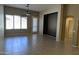 Open living room with tile flooring, ceiling fan, back patio access, and an architectural cut-out at 8014 W Beaubien Dr, Peoria, AZ 85382