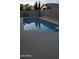 Inviting pool reflects the sky and surrounding trees, with a textured deck at 8014 W Beaubien Dr, Peoria, AZ 85382