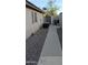 Low-maintenance side yard with gravel, a concrete walkway, and an AC unit at 8014 W Beaubien Dr, Peoria, AZ 85382