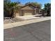 Tan home features a three-car garage, mature landscaping, and desert-style curb appeal at 840 W Crooked Stick Dr, Casa Grande, AZ 85122