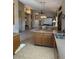 Kitchen with tiled floors, wooden cabinets, and a view into the open living and dining areas at 840 W Crooked Stick Dr, Casa Grande, AZ 85122