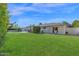 Large, well-manicured backyard with lush lawn, privacy landscaping, an outdoor seating, and a sparkling pool at 8582 E Via De Dorado --, Scottsdale, AZ 85258