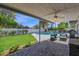 Relaxing backyard with a covered patio, lush lawn, a sparkling pool, and white block fencing at 8582 E Via De Dorado --, Scottsdale, AZ 85258