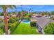 Green backyard with pool, lounge chairs, and beautifully manicured landscaping offer a private oasis with mountain views at 8582 E Via De Dorado --, Scottsdale, AZ 85258