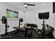 Well-lit exercise room featuring modern equipment, including a weight rack, bike, and black rubber flooring at 8582 E Via De Dorado --, Scottsdale, AZ 85258