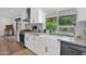 Well-lit kitchen featuring stainless steel appliances, light gray countertops, and a view to the backyard garden at 8582 E Via De Dorado --, Scottsdale, AZ 85258