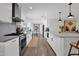 Modern kitchen featuring sleek white cabinets, stainless steel appliances, and a spacious island with bar seating at 8582 E Via De Dorado --, Scottsdale, AZ 85258
