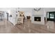 Bright, open living room showcasing a decorative fireplace, hardwood floors, and views into the kitchen area at 8582 E Via De Dorado --, Scottsdale, AZ 85258