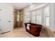 Luxurious bathroom with a copper standalone tub, glass shower, and white shuttered windows for natural light at 9208 N 83Rd St, Scottsdale, AZ 85258
