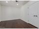 Bedroom showcasing hardwood floors, white walls, ceiling fan and view of closet at 9208 N 83Rd St, Scottsdale, AZ 85258