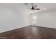 Spacious bedroom with hardwood floors, white walls, crown molding and a ceiling fan at 9208 N 83Rd St, Scottsdale, AZ 85258