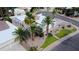 Home with desert landscaping, palm trees, and a well-maintained lawn on a sunny day at 9208 N 83Rd St, Scottsdale, AZ 85258