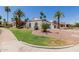 Expansive single-story home with desert landscaping, a circular driveway, and towering palm trees at 9208 N 83Rd St, Scottsdale, AZ 85258