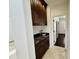 Hallway with wooden cabinets, marble countertop, and an open doorway leading to other rooms at 9208 N 83Rd St, Scottsdale, AZ 85258