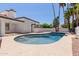 Beautiful pool area with mature palm trees, and a covered patio at 9208 N 83Rd St, Scottsdale, AZ 85258