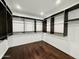 Spacious walk-in closet with dark wood shelving and rods, providing ample storage space at 9208 N 83Rd St, Scottsdale, AZ 85258