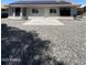 Backyard featuring a gravel area, concrete patio, and solar panels on the roof at 9807 W Mcrae Way, Peoria, AZ 85382