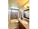Bathroom with shower and tub combination, wooden vanity, and neutral color scheme at 9807 W Mcrae Way, Peoria, AZ 85382