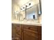 Bathroom featuring double vanity, quartz countertop, contemporary lighting fixtures, and mirrors at 9807 W Mcrae Way, Peoria, AZ 85382