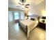 Bright bedroom with a ceiling fan, comfortable queen-sized bed, and window to the outdoors at 9807 W Mcrae Way, Peoria, AZ 85382