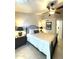 Bedroom features a ceiling fan, comfortable queen-sized bed, and neutral decor at 9807 W Mcrae Way, Peoria, AZ 85382