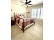 Bedroom with comfortable iron bed frame, red patterned bedspread and bright shuttered windows at 9807 W Mcrae Way, Peoria, AZ 85382