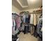 Spacious walk-in closet featuring extensive storage with multiple rods and shelving at 9807 W Mcrae Way, Peoria, AZ 85382
