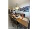 Dining room features an elegant light fixture over a wooden table with seating for six at 9807 W Mcrae Way, Peoria, AZ 85382
