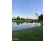 Scenic view of a golf course with palm trees and water features on a clear day at 9807 W Mcrae Way, Peoria, AZ 85382