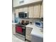 Well-lit kitchen with stainless steel microwave and oven, plus light wood cabinets at 9807 W Mcrae Way, Peoria, AZ 85382