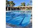 Community pool with clear water, lounge seating, and well-maintained surroundings under a bright sky at 9807 W Mcrae Way, Peoria, AZ 85382