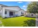 A spacious backyard with a well-maintained lawn and covered patio, ideal for relaxation and entertainment at 10034 E Thunderbolt Ave, Mesa, AZ 85212
