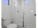 Clean bathroom featuring a toilet, tiled shower, and white walls at 10034 E Thunderbolt Ave, Mesa, AZ 85212