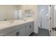 Modern bathroom featuring a double vanity, mirror, and glass enclosed shower at 10034 E Thunderbolt Ave, Mesa, AZ 85212