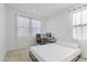 Bright bedroom with a comfortable bed, a work station, and natural light from the window at 10034 E Thunderbolt Ave, Mesa, AZ 85212