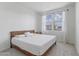 Neutral bedroom with a queen-sized bed, carpet, and natural light at 10034 E Thunderbolt Ave, Mesa, AZ 85212